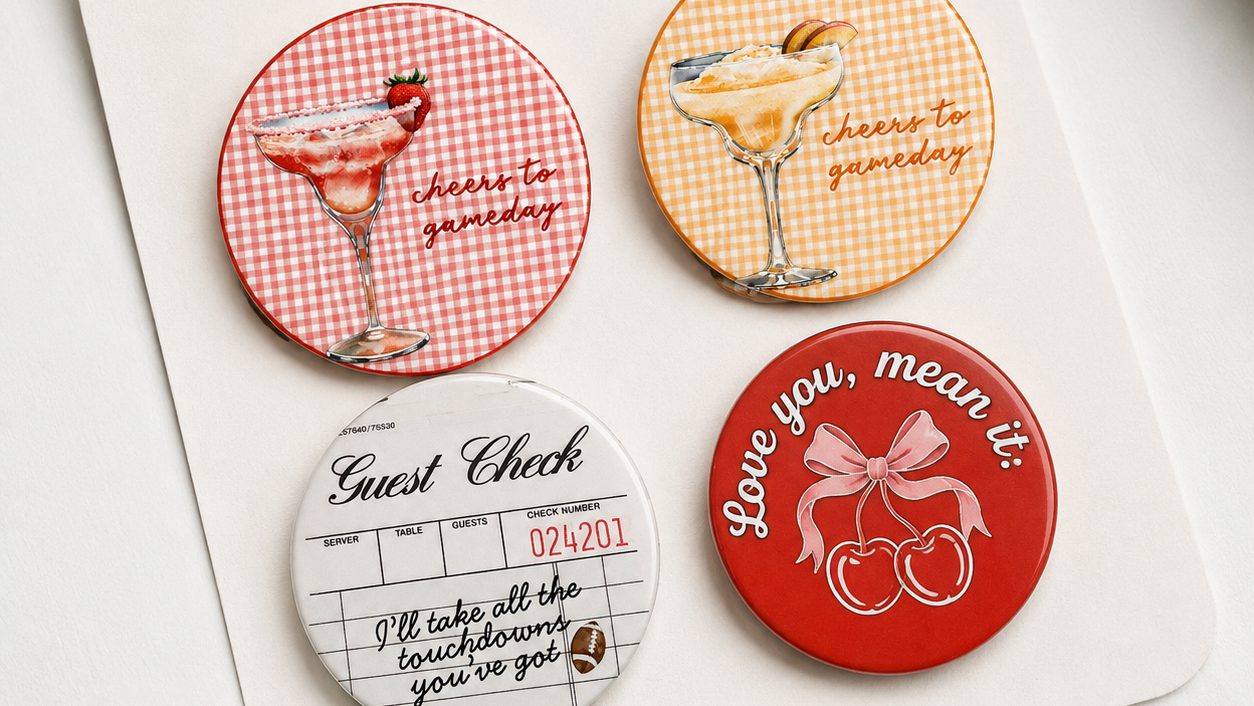 Set of four decorative buttons with various designs on a white card, featuring the brand 'Pinned It'.